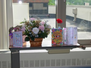 We spent Mother's Day 2009 with my mother in the intensive care unit at St. Mary's Hospital. We used this tray table in her room to hold her cards and a flower arrangement my sister and I created using silk flowers. Mom and I had taken a flower-arranging class years before and enjoyed it very much. (Note the handle of my father's cane to the right of the tray table. At that time, my father used his cane in a cavalier manner, often placing it where it would do him no good. He lost it several times, so eventually we put our names and my phone number on it.)  